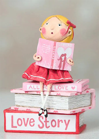 Hand-painted “Love Story” figurine by Lori Mitchell—sweet girl in pink and red dress perched atop a stack of romance books, lost in a love story